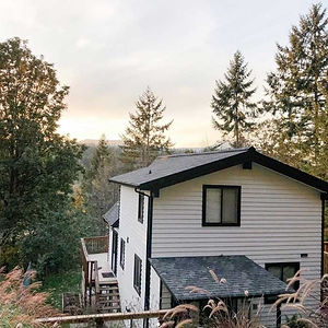 The same home repainted in white with black trim