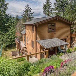 Cedar-sided home with weathered brown stain before repainting